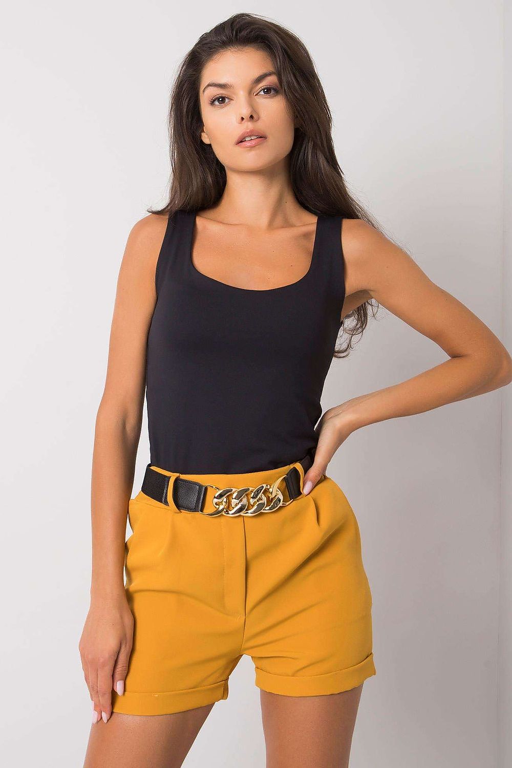 Elegant close-up of Luxury Women's Elastic Waistband Shorts with Slip Pockets and Decorative Belt by Italy Moda, featuring the stylish combination of a black top and yellow shorts.