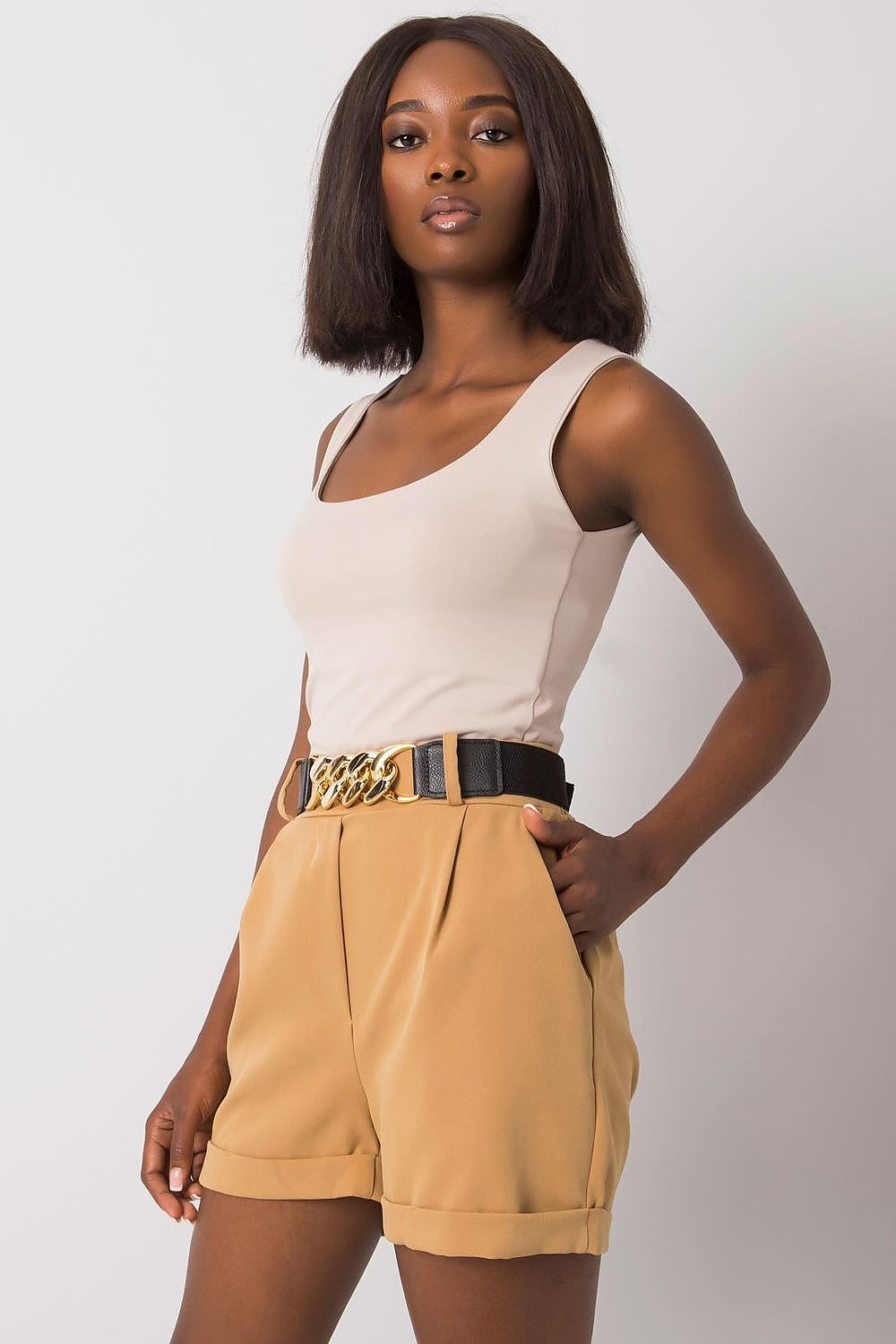 Stylish model in Luxury Women's Elastic Waistband Shorts with Slip Pockets and Decorative Belt by Italy Moda, effortlessly fashionable in a beige aesthetic.