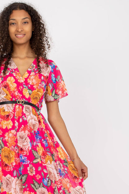 Floral Summer Dress with Belt and Pleated Hem by Italy Moda - Elegant Flared Design. The front view captures the model's grace in the pink floral dress, accentuated by a stylish belt, epitomising summer sophistication.