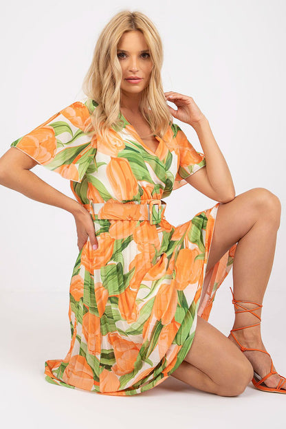 Elegant Summer Dress with Frill Sleeves, Envelope Neckline and Pleated Bottom by Italy Moda, featuring a stunning floral design in orange and green, model posed elegantly kneeling to highlight the dress’s exquisite details.