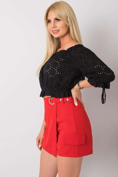Luxury Red Women's Shorts By Italy Moda with distinctive imitation pockets, model exuding grace and style, complemented by a trendy black crop top.