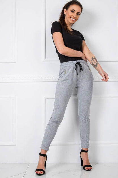 BFG Women’s High-Waisted Slim Leg Tracksuit Trousers showcased on a model, styled with a black top and elegant heeled sandals, highlighting the comfortable cotton blend fabric and fashionable silhouette.