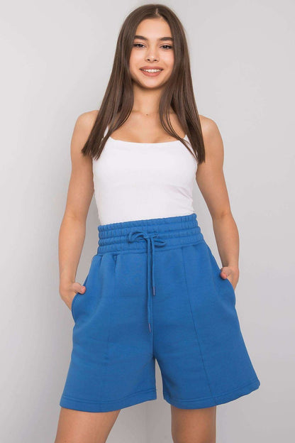 Chic model wearing Elegant Cotton Women's Shorts with Elastic Waistband and Slip-On Pockets by BFG in vibrant blue, exuding luxury and contemporary style, complemented by a simple white top.