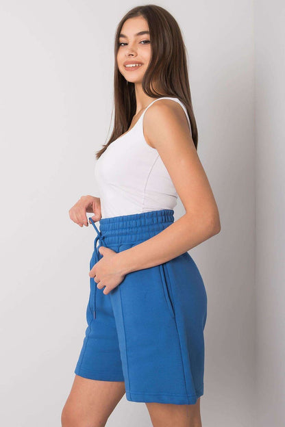 Elegant Cotton Women's Shorts with Elastic Waistband and Slip-On Pockets by BFG, model smiling while wearing blue shorts, demonstrating side pocket functionality and a relaxed fit.