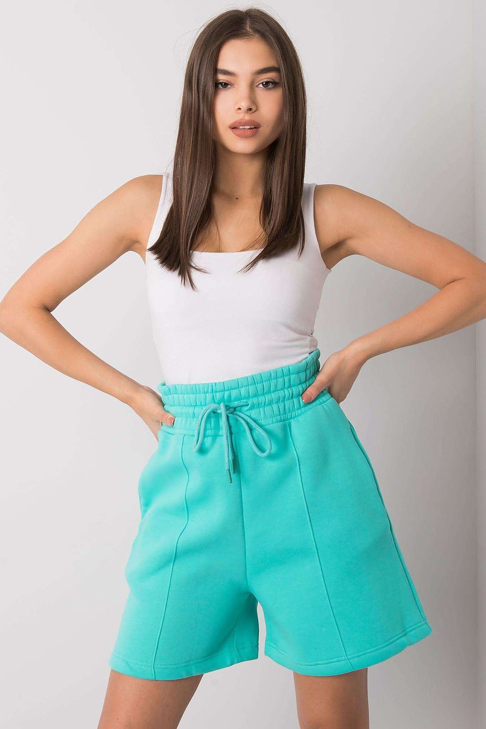 Elegant Cotton Women's Shorts with Elastic Waistband and Slip-On Pockets by BFG, model posing in vibrant turquoise shorts, emphasising comfort and style.