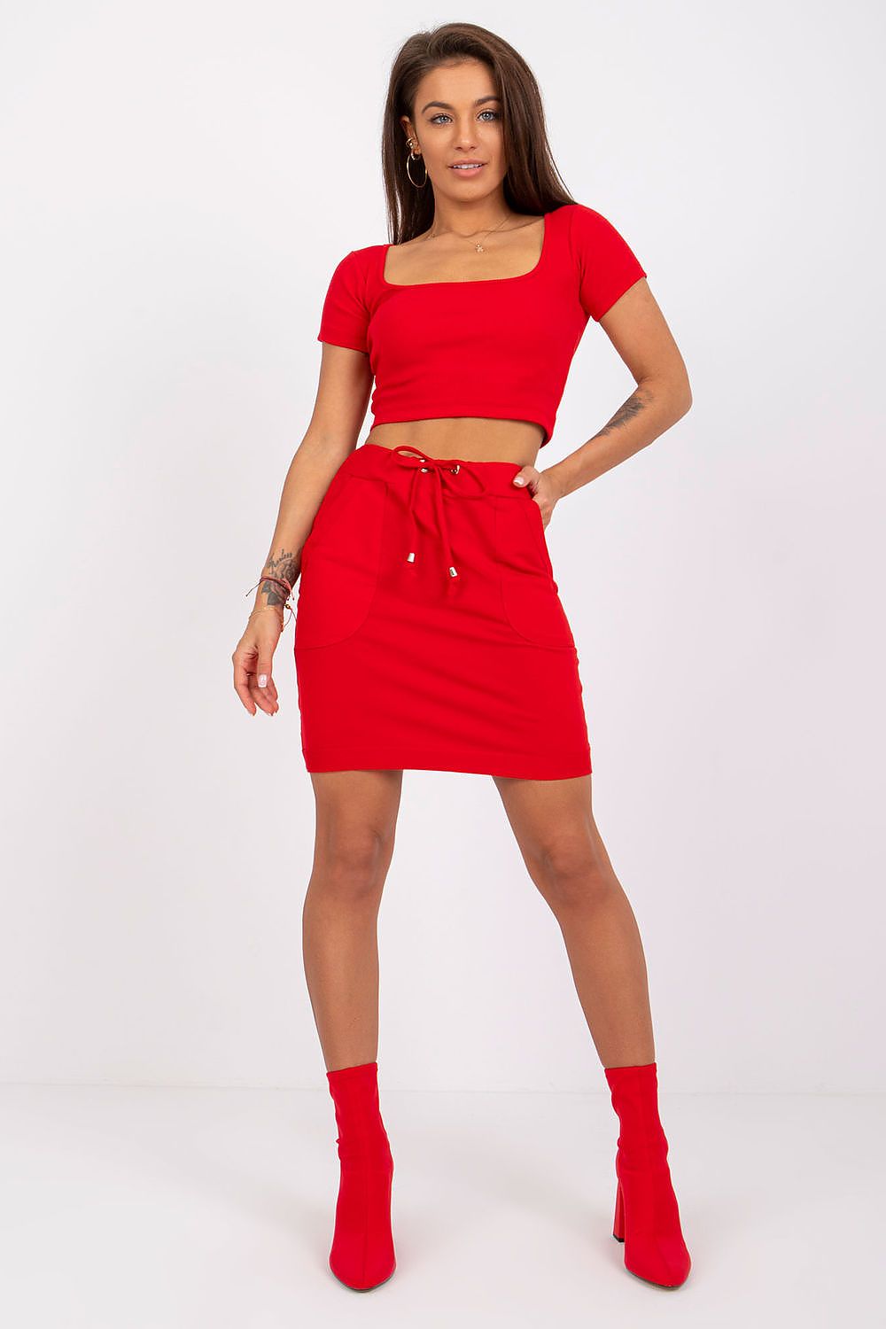 Luxury Cotton Mini Skirt with Elastic Waistband - Stylish Casual Look by BFG, featuring a model in a vibrant red mini skirt and matching crop top, styled with high-heeled boots.