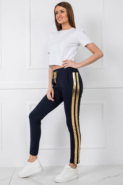 Luxury Women's Tracksuit Trousers with Elastic Waistband and Contrasting Side Stripes, elegantly styled on a model, highlighting the gold accented side stripes and casual chic look.