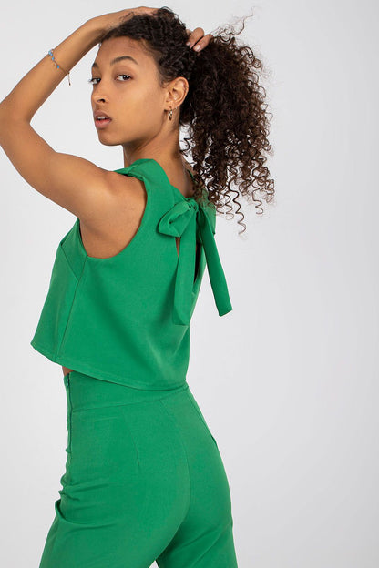 Elegant Italy Moda Blouse and Long Pants Set - Sleeveless Tie-Back Design, High Waist Trousers. Close-up of model in green, highlighting the exquisite tie-back detail of the top.