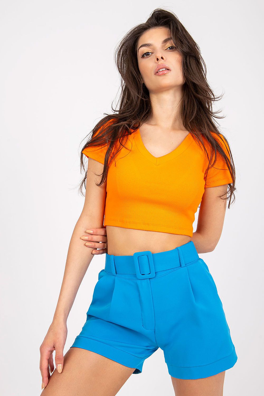 Elegant Women's Italy Moda Shorts With Zip Closure, Side Pockets & Matching Belt - model displays stylish blue shorts and a bright orange top, a stunning look for a sophisticated summer wardrobe.