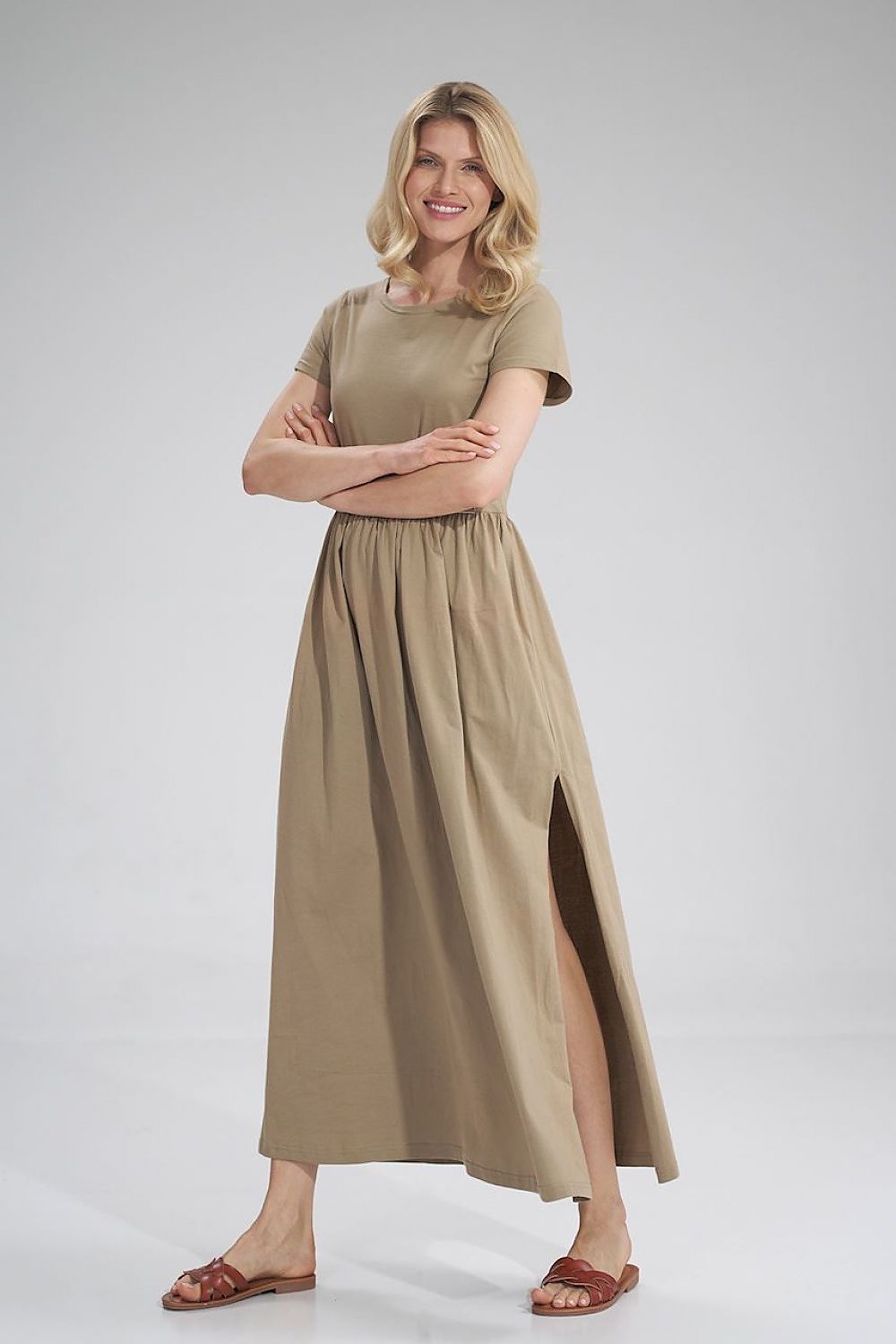Luxury Figl Summer Cotton Maxi Dress displayed on a model smiling, wearing a beige short-sleeved dress with a stylish pleated waist and side slit.