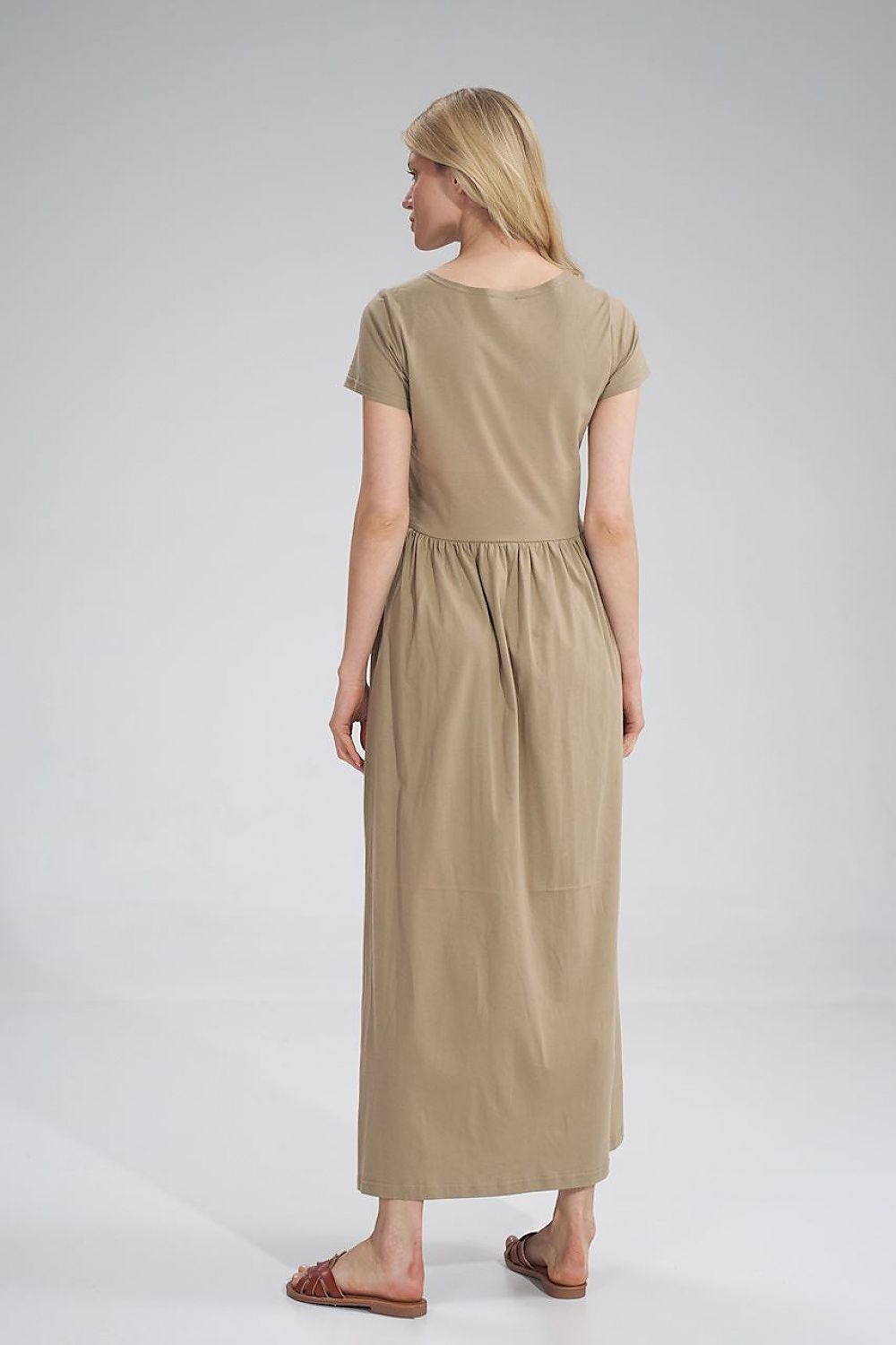 Luxury Figl Summer Cotton Maxi Dress from the back, highlighting the elegant pleated waist design on a model wearing a beige maxi dress.