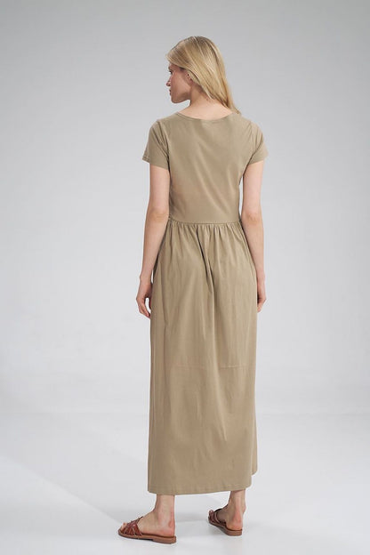 Luxury Figl Summer Cotton Maxi Dress from the back, highlighting the elegant pleated waist design on a model wearing a beige maxi dress.