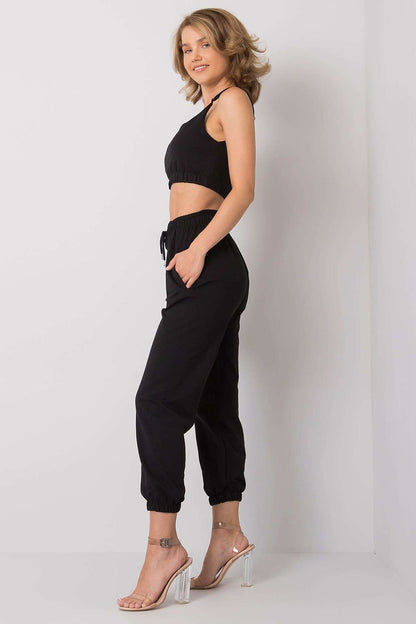 Ex Moda Women's Sports Set presented on model in profile, adjustable strap top and elastic waist sweatpants with pockets highlight a sophisticated sporty look.