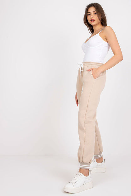 Model posing gracefully in Ex Moda Women's Cotton-Blend Sweatpants with Elastic Waistband and Slip-On Pockets, styled with a casual white fitted top, highlighting the trendy yet comfortable look.