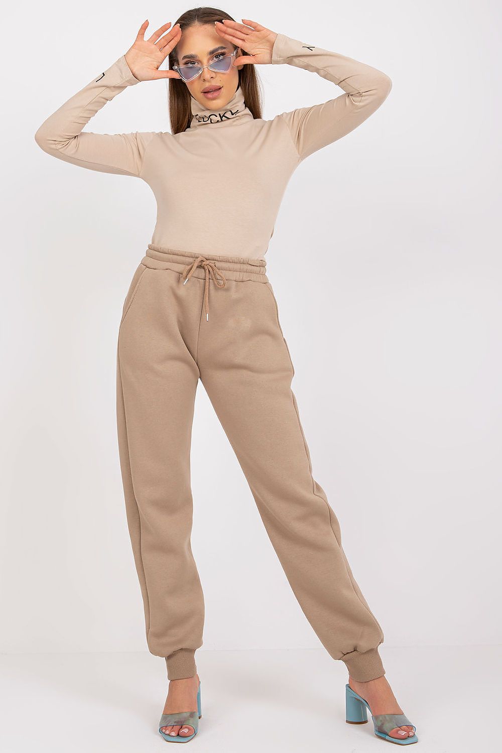 Ex Moda Women's Tracksuit Trousers - Cotton Blend, Elastic Waist, Slip-On Pockets styled with a beige top, highlighting a sophisticated yet comfortable ensemble.