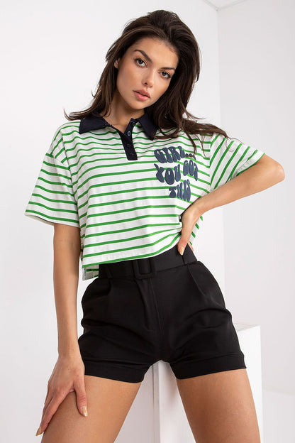 Stylish Striped Cotton Polo Blouse with Decorative Print, showcasing a model wearing a green and white striped short-sleeve polo with a navy collar and bold graphic print, paired with tailored black shorts.