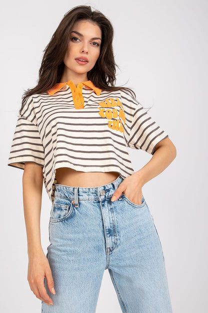 Stylish Striped Cotton Polo Blouse with Decorative Print, showcasing a model in a luxurious beige and brown striped polo with orange details, elegantly styled with high-waisted denim jeans.
