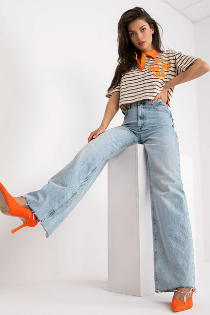 Stylish Striped Cotton Polo Blouse with Decorative Print, featuring a model striking a pose in an elegant striped polo paired with wide-leg jeans and vibrant orange heels, epitomising modern chic.