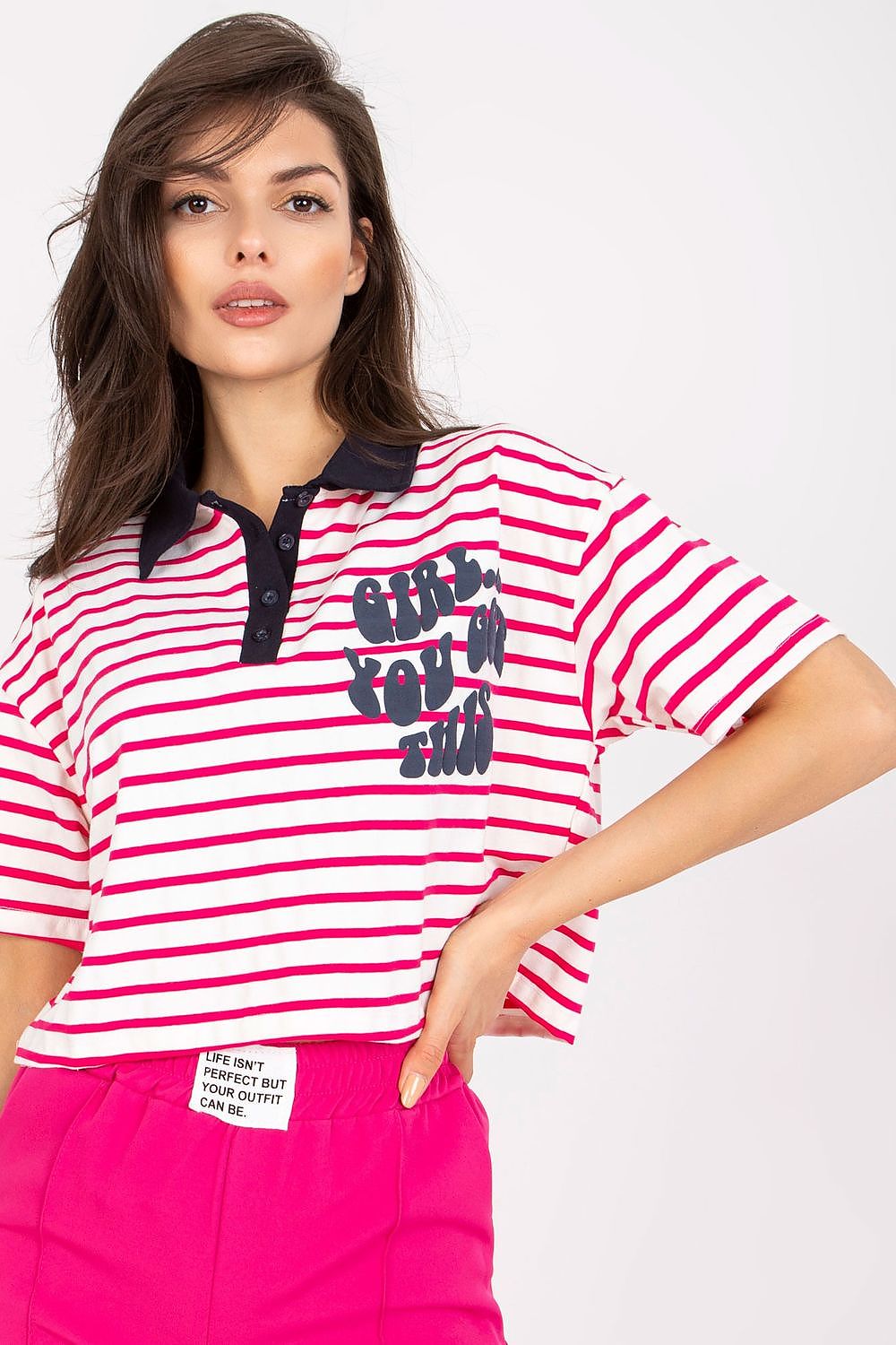Stylish Striped Cotton Polo Blouse with Decorative Print – EU Size 0, highlighted by a model displaying the blouse with vibrant red and white stripes, paired with pink trousers.