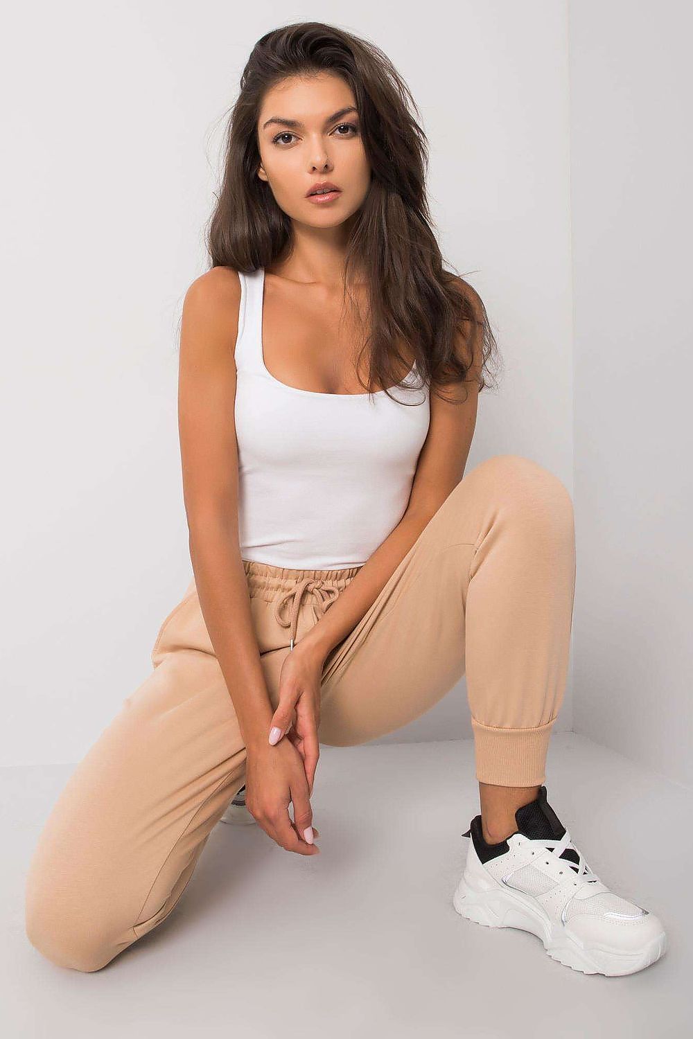 Luxury Tracksuit Trousers with Waist Tie and Elastic Band - Comfortable Cotton Blend Sweatpants model posing in light beige sweatpants, highlighting comfort and style.