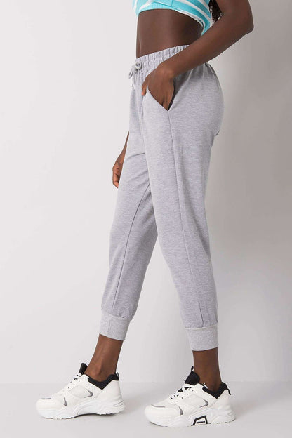 Luxury Tracksuit Trousers with Waist Tie and Elastic Band - Comfortable Cotton Blend Sweatpants model in dynamic pose wearing grey sweatpants, emphasising comfort and fashion.