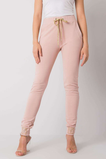 Luxury High Rise Sweatpants with Rhinestone Cuffs and Tie Waist - Cotton Spandex Blend, showcasing a model wearing soft pink pants with a gold tie at the waist and rhinestone details at the cuffs.