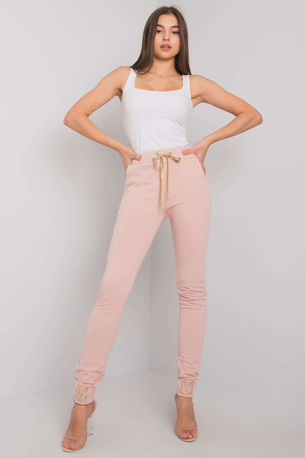 Luxury High Rise Sweatpants with Rhinestone Cuffs and Tie Waist - Cotton Spandex Blend, featuring a model in a pink outfit striking a pose, highlighting the elegant design and gold tie of the sweatpants.