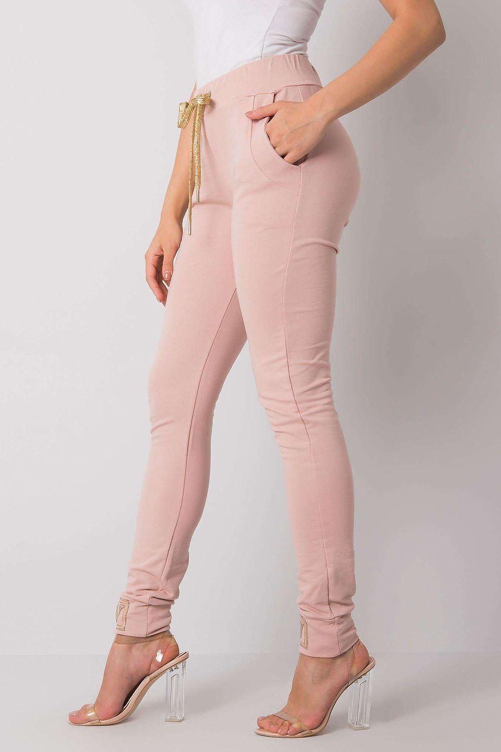 Luxury High Rise Sweatpants with Rhinestone Cuffs and Tie Waist - Cotton Spandex Blend, side view of a model demonstrating the stylish pockets and fit of the pink sweatpants.