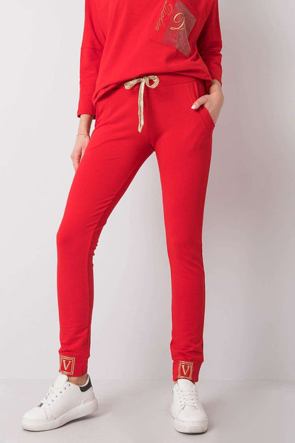 Luxury High Rise Sweatpants with Rhinestone Cuffs and Tie Waist - Cotton Spandex Blend, model in red sweatpants styled with a luxurious oversized top and trendy sneakers.