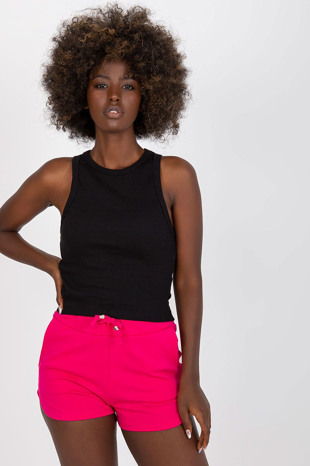 BFG Classic Ribbed T-Shirt in Black, crafted from a luxurious cotton and spandex blend, featuring a stylish round neckline and a fitted silhouette, elegantly showcased on a model wearing vibrant pink shorts.