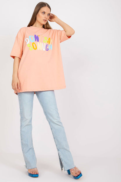 Stylish Loose-Fit Ladies' T-Shirt with Decorative Front Wording - Cotton & Spandex Blend, featuring a model in a peach t-shirt styled with flared jeans, showcasing the striking front wording.