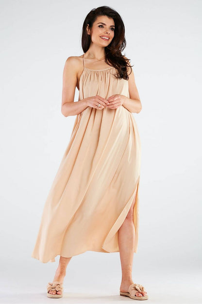 Elegant Maxi Dress by Awama displayed in a soft nude shade, emphasising the luxurious viscose material and chic side slit, ideal for elegant occasions.