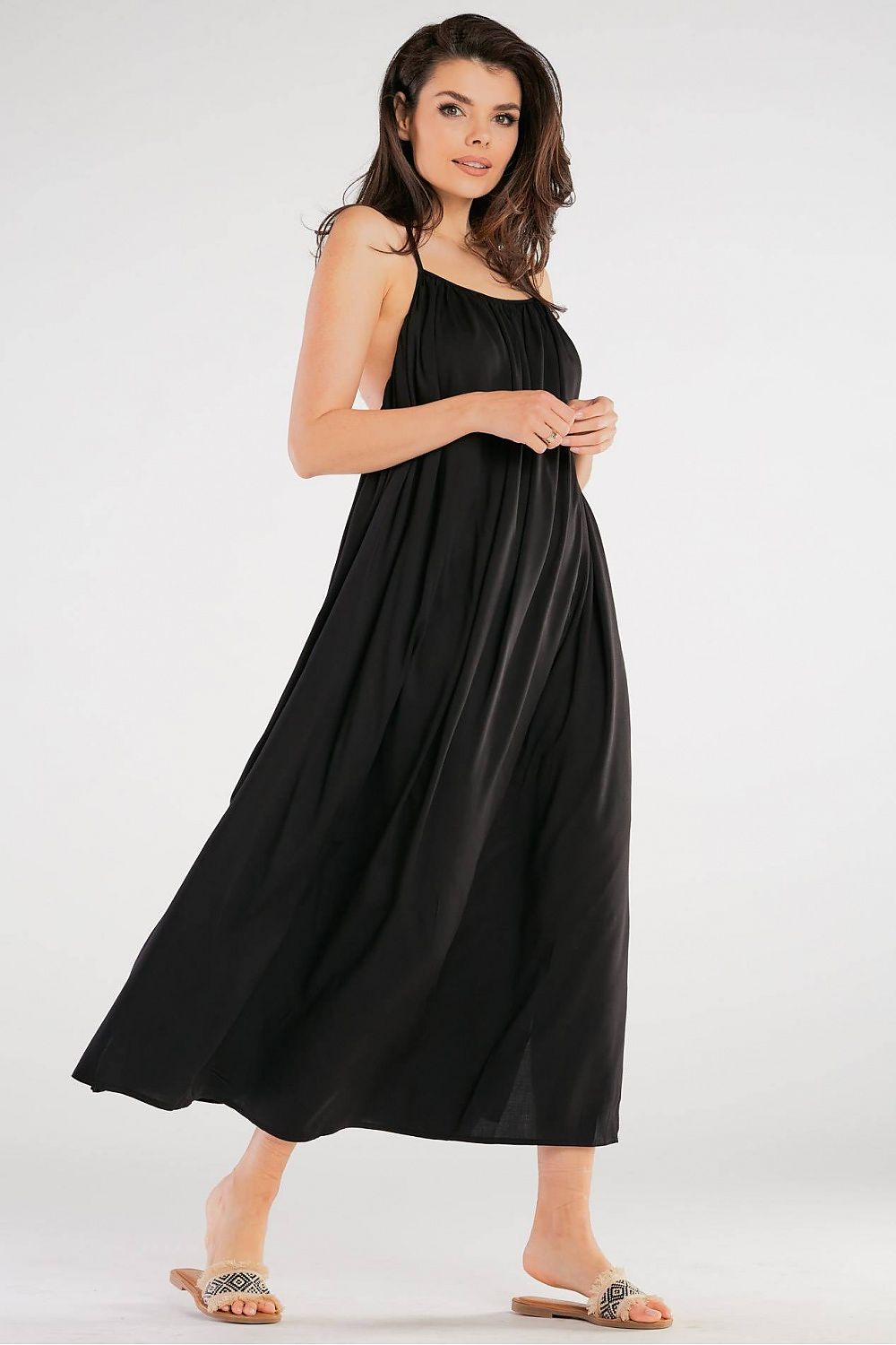 Elegant Maxi Dress by Awama with Decorative Back Ring in Airy Viscose, model posing in a stunning black version of the dress that features a flowing silhouette.