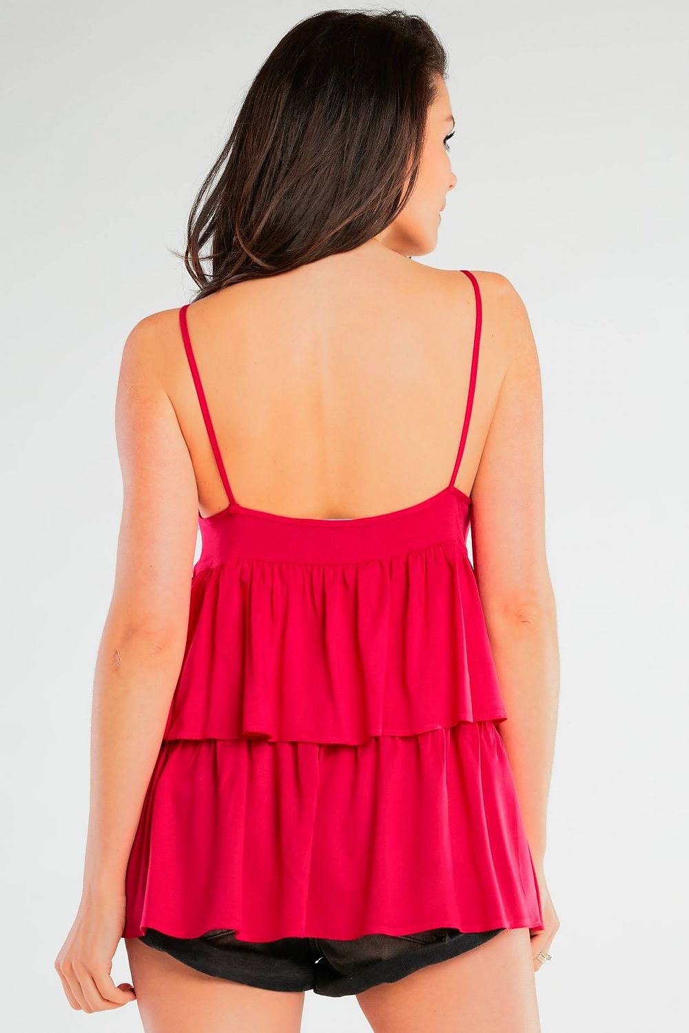 Back view of a model in an elegant loose-fitting viscose blouse with thin straps and frill detailing by Awama, highlighting the exquisite design and vibrant red colour.
