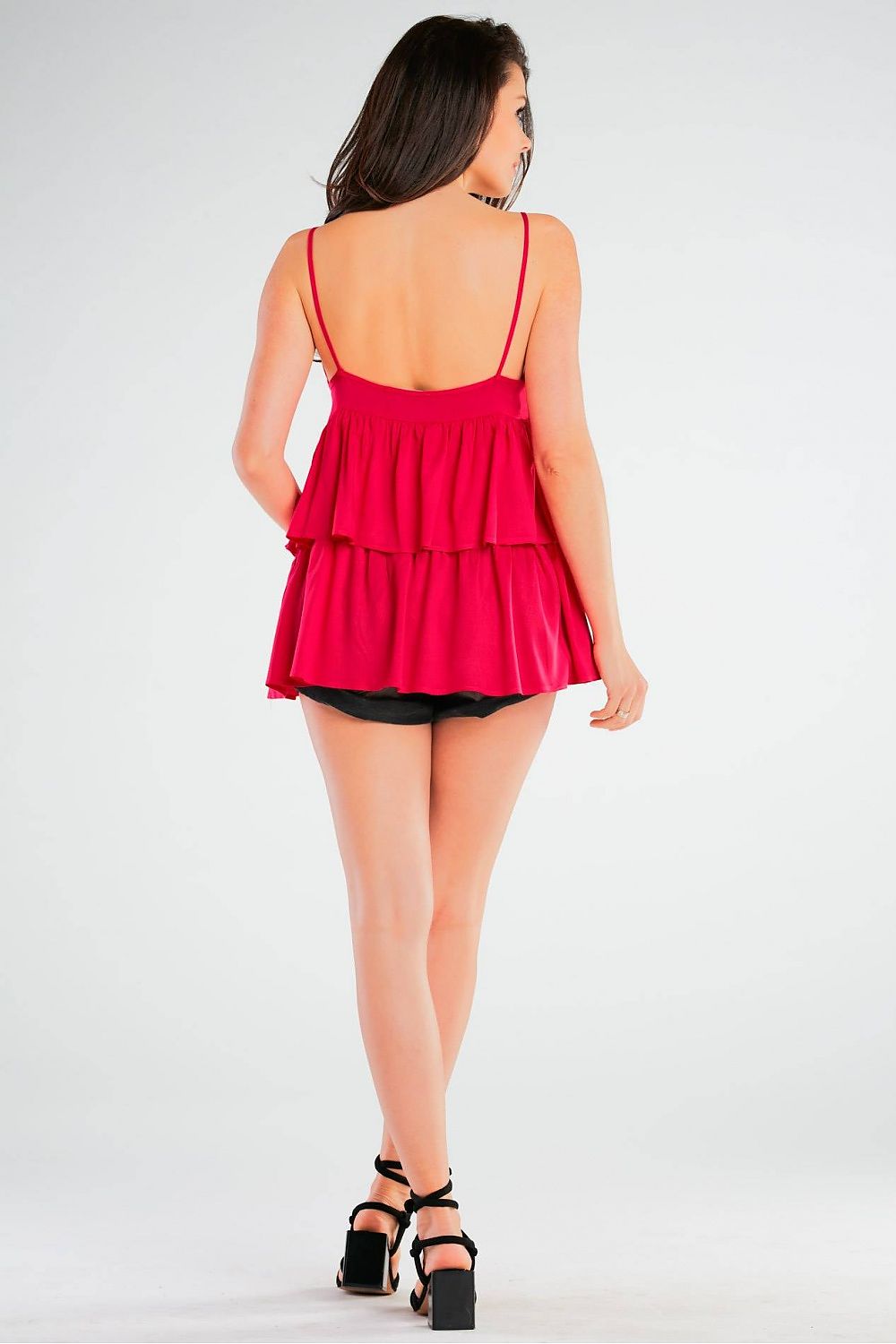 Another angle of a model wearing an elegant loose-fitting viscose blouse with thin straps and frill detailing by Awama, showcasing the stylish and luxurious design tailored for modern elegance.