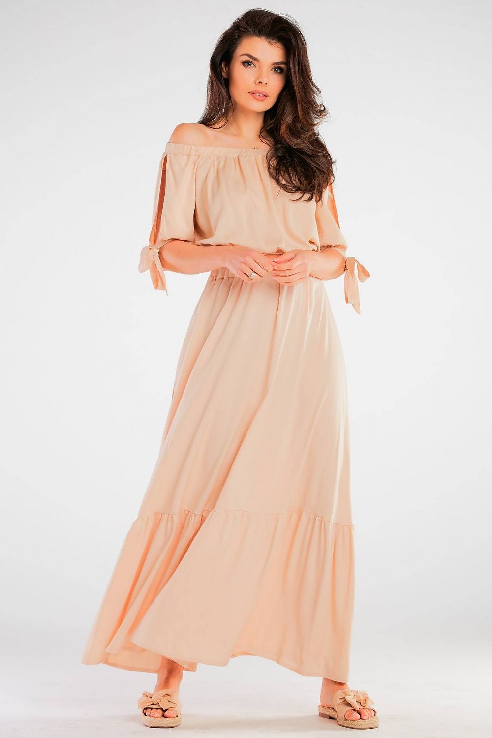 Elegant Maxi Skirt with Frill Detail, featuring a model wearing a soft peach-coloured maxi skirt with frill detail, made from a viscose blend with an elastic waist, perfect for summer events.