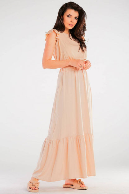 Elegant Maxi Skirt with Frill Detail, featuring a close-up of a model dressed in a peach maxi skirt with a frill detail, perfectly styled for summer parties, made from breathable viscose.
