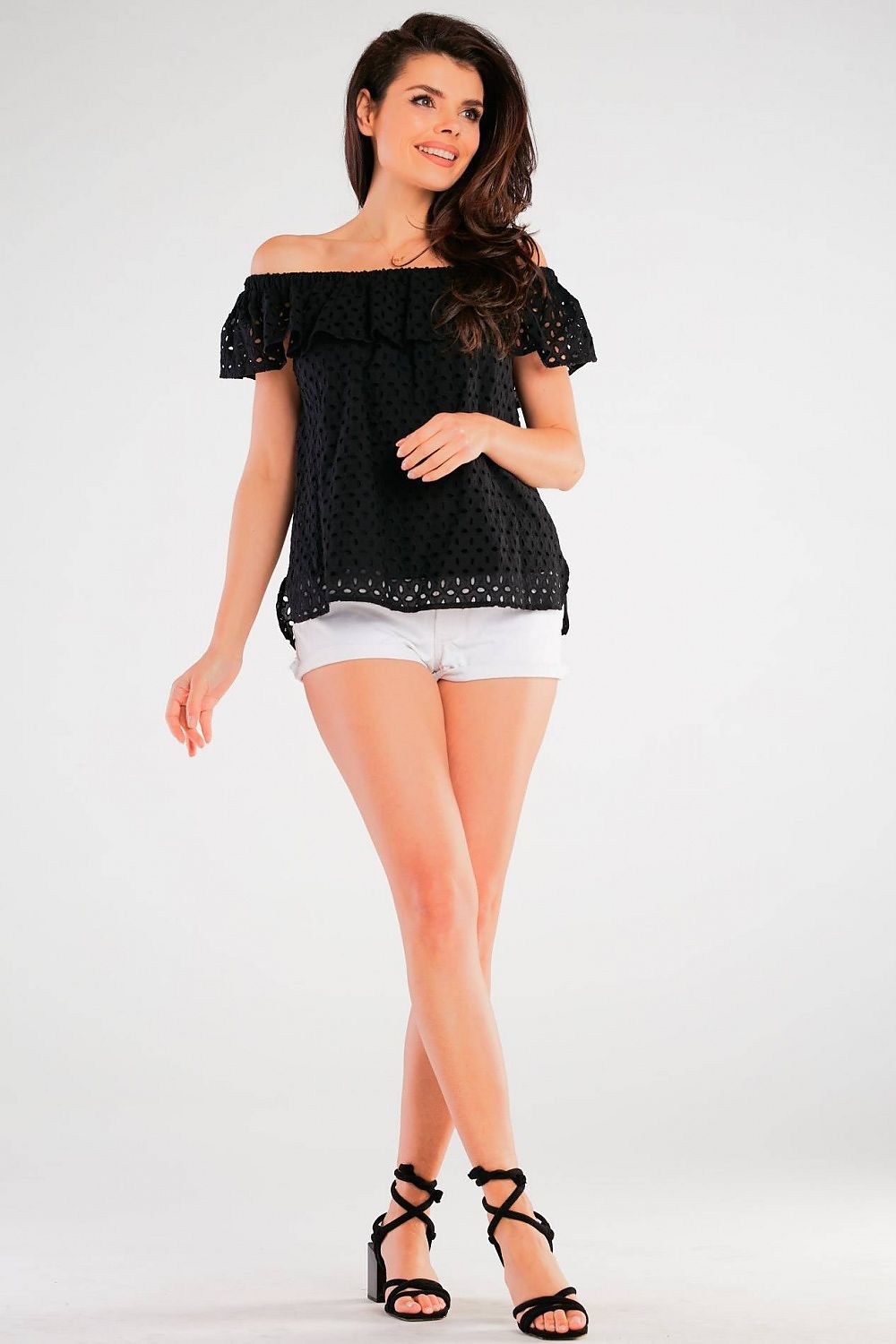 Model showcasing the Airy Spanish-Style Blouse by Awama in a picturesque pose, capturing the essence of relaxed summer fashion with a chic black cotton frill top.
