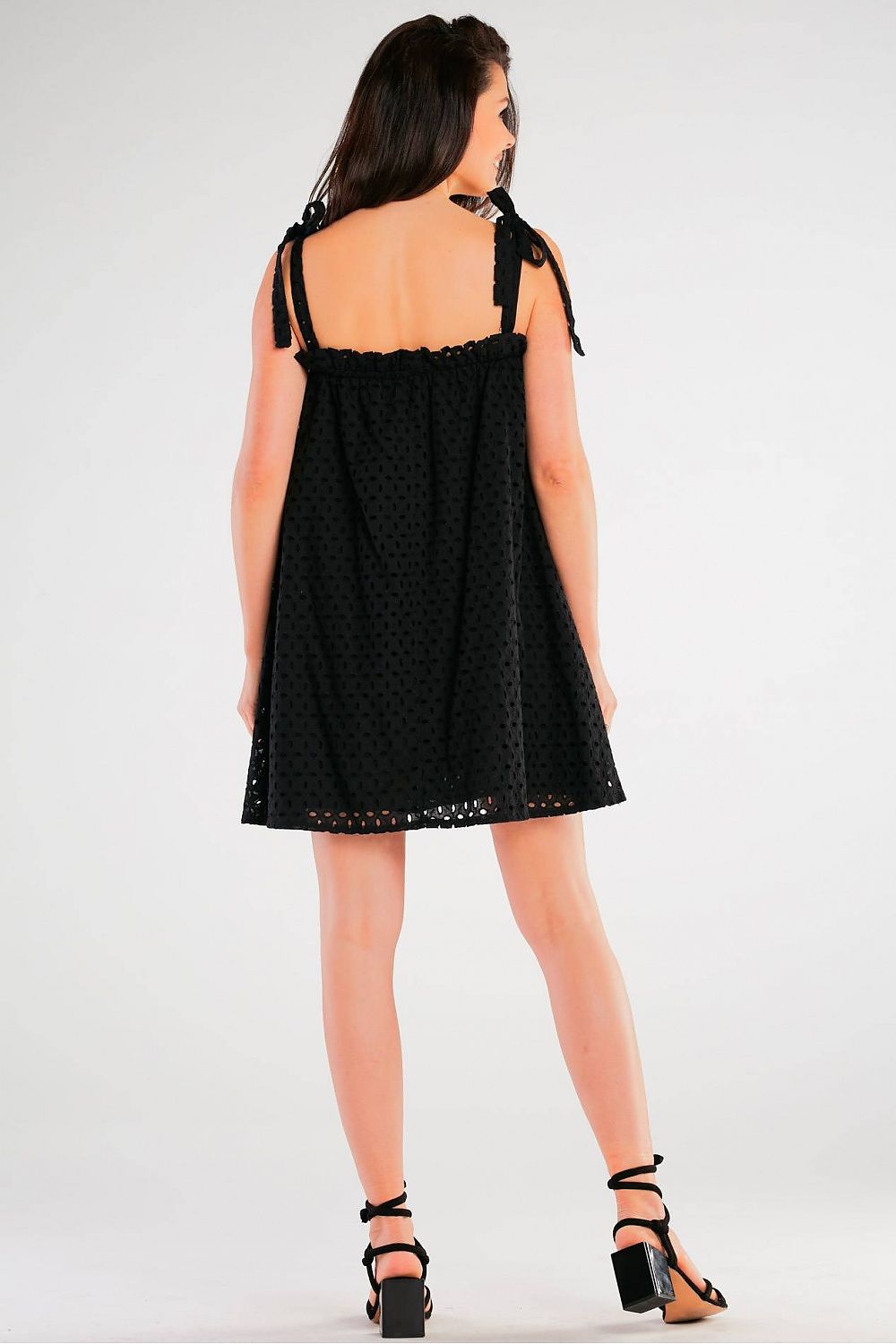 Elegant Flared Cotton Daydress with Tied Straps and Pleated Neckline by Awama - Made in Poland, back view of model in black dress highlighting its flared design.