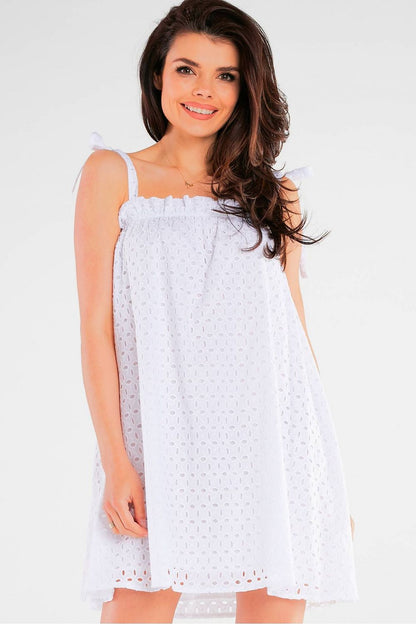 Elegant Flared Cotton Daydress with Tied Straps and Pleated Neckline by Awama - Made in Poland, model displaying the white version of the dress with a radiant smile.