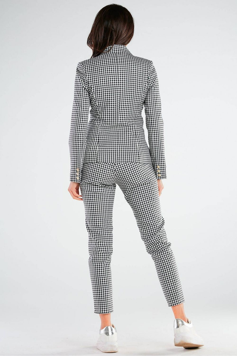 Elegant Women's Fitted Trousers with Pockets in Unique Patterns by Awama viewed from the back, highlighting the sophisticated black and white checkered suit, emphasizing the tailored design and the model's silhouette.