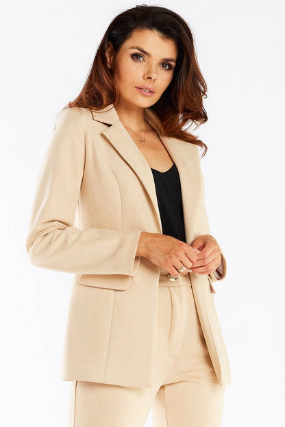Elegant Women's Awama Jacket With Shawl Collar And Golden Button - Model poised in a beige tailored jacket, showcasing its elegant design and golden detailing.