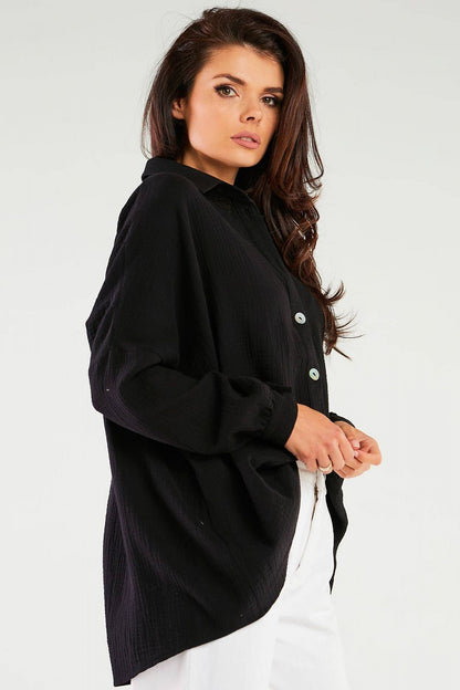 Elegant Oversized Long Sleeve Shirt with Adjustable Neckline by Infinite You, shown in a black colour on a model posing sideways, highlighting the shirt’s loose fit.