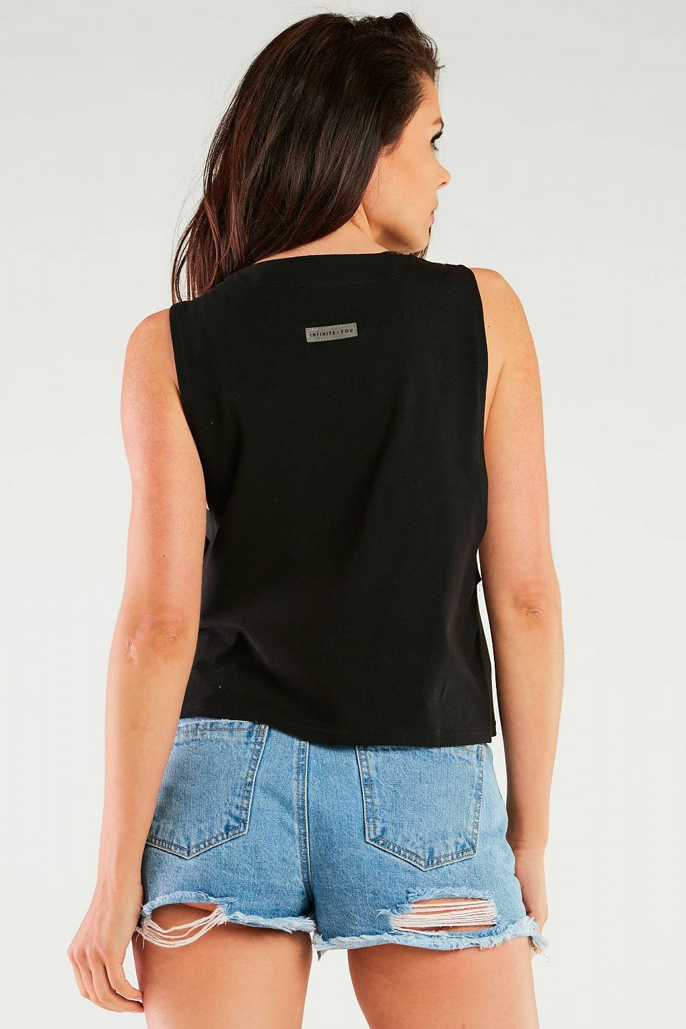 Back view of the Luxury Cotton Blouse by Infinite You, paired with distressed denim shorts, exuding casual sophistication.