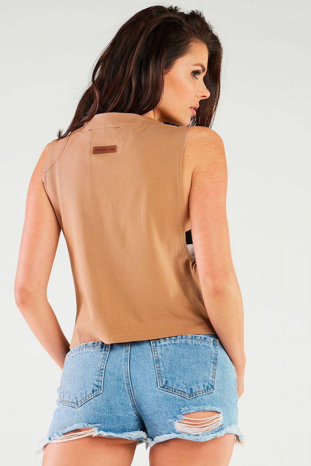 Luxury Cotton Blouse by Infinite You, featuring a side back view in beige with denim shorts, illustrating a blend of luxury and modern style.