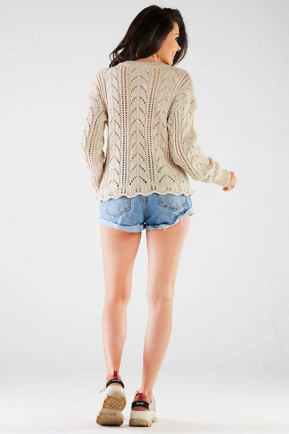 Back view of the Luxury Ladies Sweater by Awama, demonstrating the timeless ribbed finish and airy knit design, paired with stylish denim shorts.