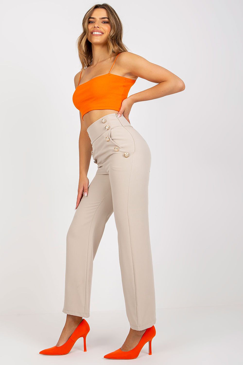 Luxury Women's High-Waisted Trousers with Decorative Buttons showcased on a model wearing an orange crop top and vibrant heels, highlighting elegance and sophistication.