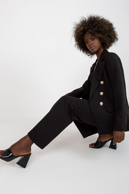 Stylish Ladies' Jacket by Italy Moda displayed in a seated pose, exhibiting refined tailoring and sophistication in black.