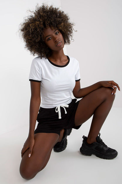 Ex Moda Ladies 2-Piece Cotton T-Shirt and High Waisted Shorts Set with Pockets, featuring a stylish model presenting a chic white t-shirt with black trim paired with high-waisted black shorts, exuding modern elegance.