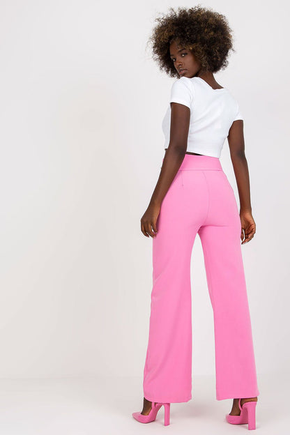Back view of a model in Luxury Women'S High-Waisted Trousers with Decorative Buttons in pink, paired with a cropped top, showcasing the pant’s chic appearance.